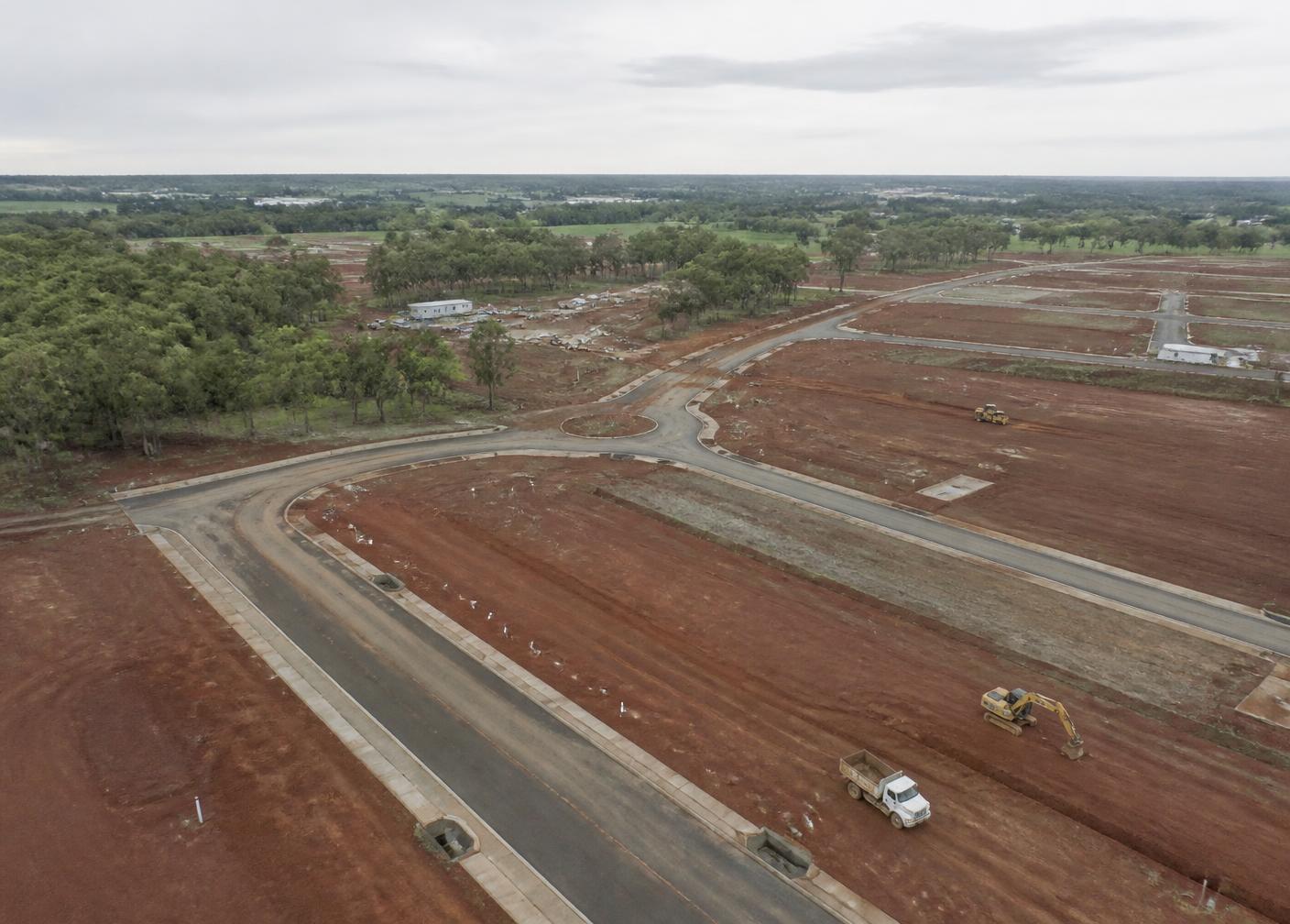Land parcel being developed with newly laid roads, kerbs and drainage infrastructure